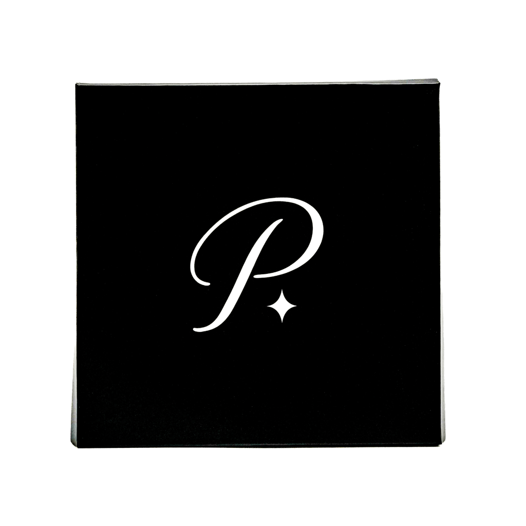 White PRISTINE P monogram on black square packaging against a white background.