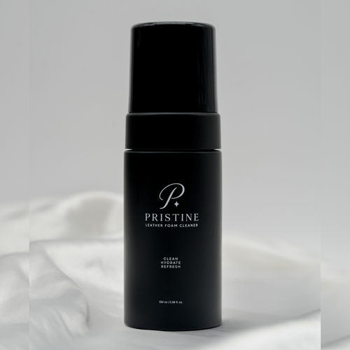 PRISTINE Leather Foam Cleaner 100 mL bottle standing on white fabric.